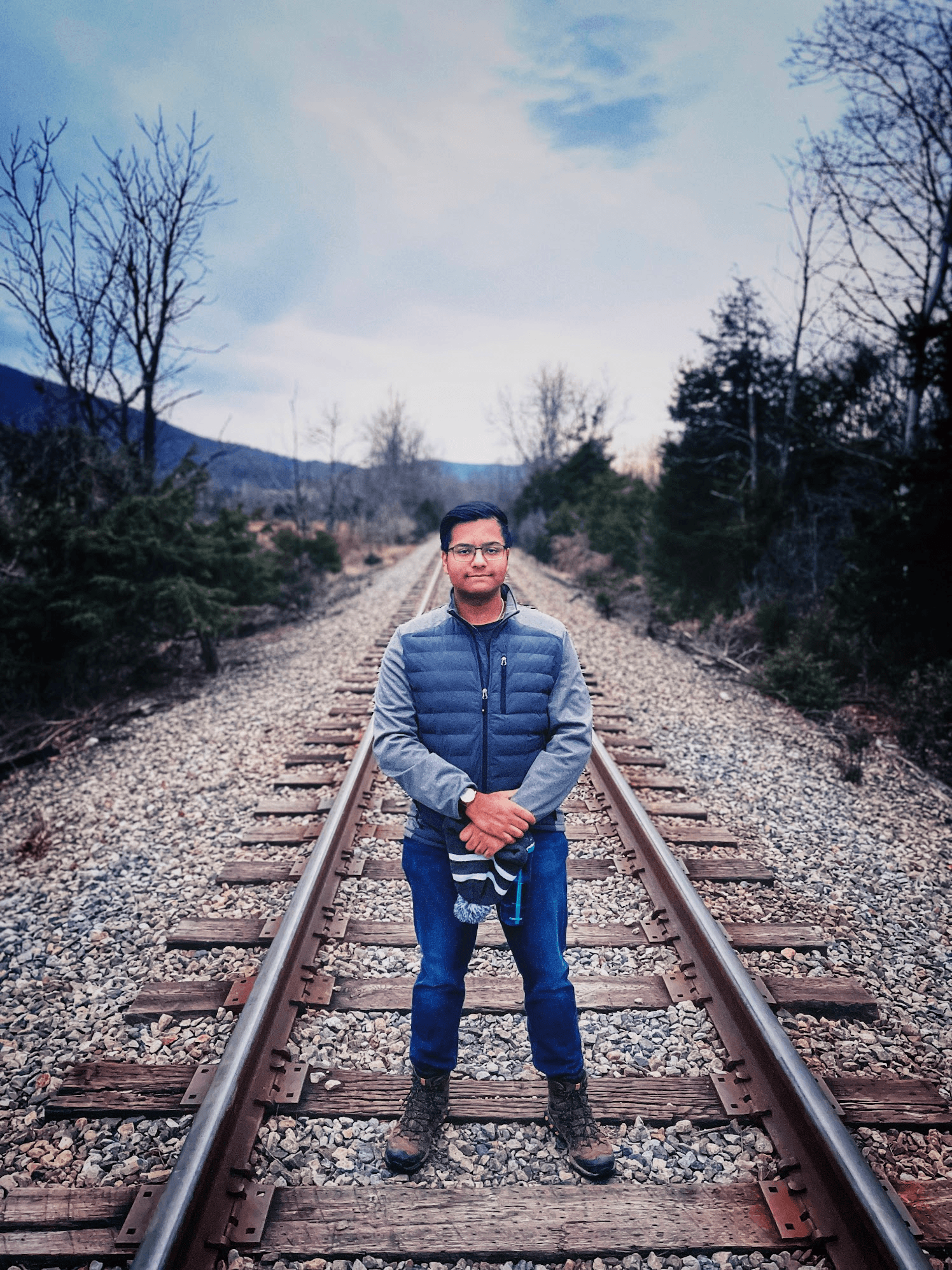 Sumantra Chattopadhyay in hiking clothes on railroad track